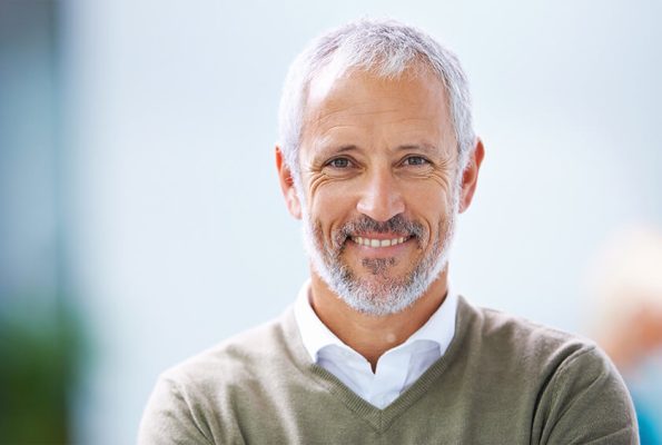 man smiling with dental implants