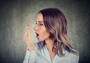 woman checks bad breath with breath test